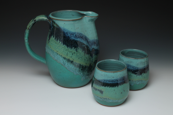 pitcher with cups in mountain design