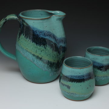 pitcher with cups in mountain design